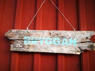 Wooden information sigh on the wooden wall