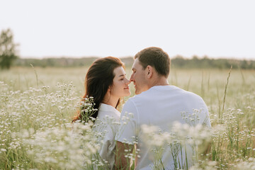 Boyfriend and Girlfriend Kissing on Floral Field