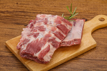 Raw pork ribs served rosemary