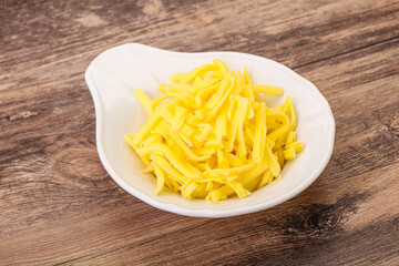 Shredded yellow cheese in the bowl