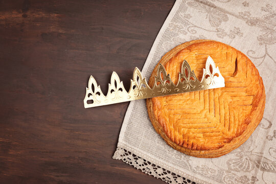 King cake or galette des rois in French. Traditional epiphany pie with golden paper crown and tiny charms