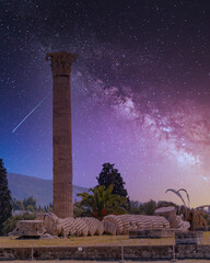 a column of Olympian Zeus ancient temple illuminated by starry night sky, Athens Greece