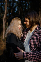 Young couple are hugging and loving each other in autumn park