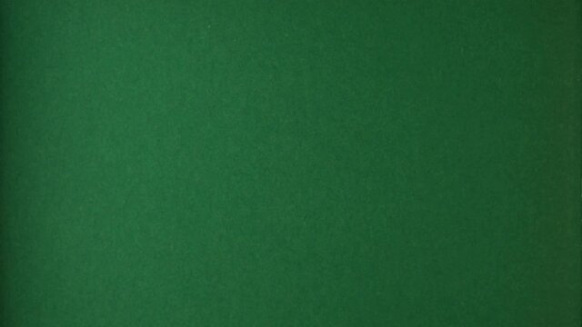 Red paper is torn over green background for message, stop motion, animation. Template for your text.