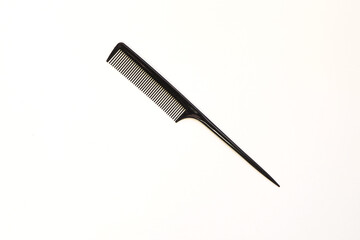 black flat plastic comb on white background. 