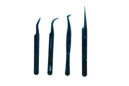 four tweezers for eyelash extension on a white background. 