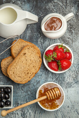 top view breakfast desk bread honey and tea on a dark floor tea food morning