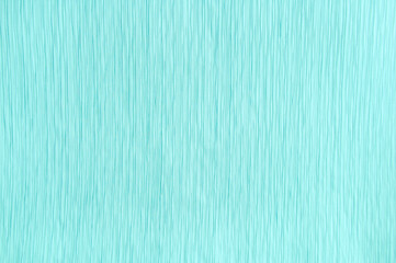 A close-up of turquoise pleated fabric. Curtains and textiles.