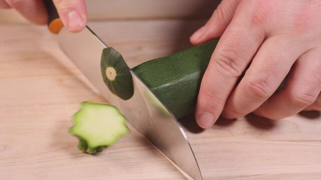 Amateur man cutting vegtables at home. Close up footage of person preparing vegan food.	
