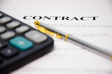 contract pen and calculator lie on a white background. sign contract.