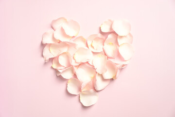 Heart made of rose petals on pink background. Happy Valentines Day concept.