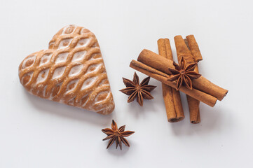 Cinnamon sticks and star anise  and cake on a white background