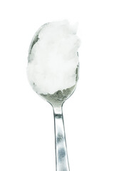Coconut oil on spoon isolated on white background top view