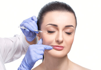 Cosmetologist makes rejuvenating anti wrinkle injections on the face of a beautiful woman. Female...