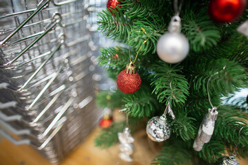 Christmas tree with Christmas decorations and decorative baskets for goods in the supermarket