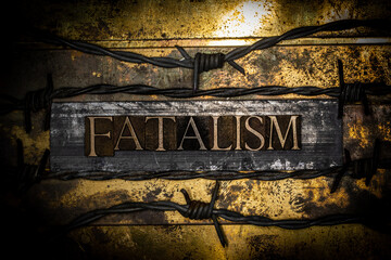 Fatalism text between barbed wire on vintage textured grunge copper and gold background