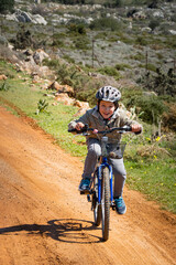 Obraz premium Boy riding bicycle on road
