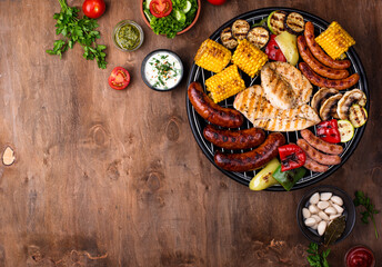 Grilled sausages, meat, and vegetables.