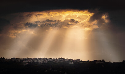 View of town with clouds at dusk