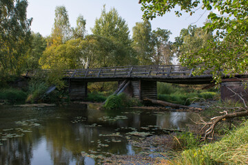 Fototapeta na wymiar Wooden bridge over the river in summer day