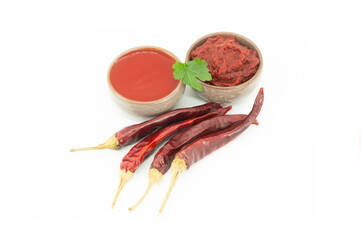 Traditional turkish chili pepper paste and sauce in dish with dried peppers isolated on white background