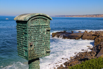 A green call box for lifeguards at La Jolla Cove in San Diego