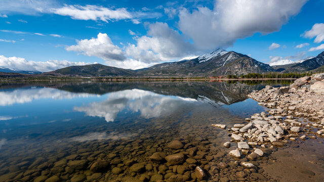 Still water lake Dillon in Colorado with mountain and cloud reflections