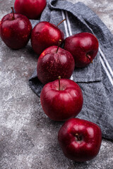 Fresh red ripe apples on gray background