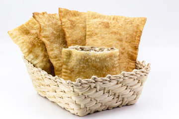 Brazilian pastry, fried dough and stuffed with ground meat, potatoes and pepper, in a handmade...