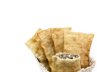 Brazilian pastry, fried dough and stuffed with ground meat, potatoes and pepper, in a handmade...