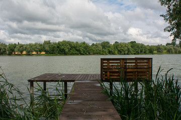 wooden pier on the lake - 400620490