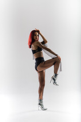 Sexy pole redhead dancer showing her body.