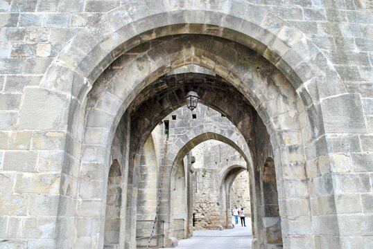 A series of arched, stone passageways in Carcassonne, a French fortified city in the region of Occitanie. The citadel, known as the Cit&eacute; de Carcassonne, is a medieval fortress and UNESCO site.