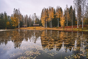autumn landscape with lake and small farm