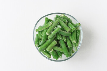 Glass plate with frozen green bean slices. Diet and maintain weight by taking healthy foods.