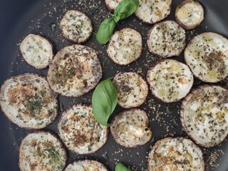 Grilled sliced aubergines with fresh basil and dried herbs