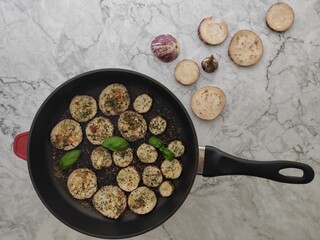 Grilled sliced aubergines with fresh basil and dried herbs