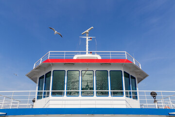 Close-up captainhouse exterior view of an empty ship with blue sky background.