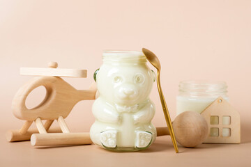 baby natural milk in a jar for newborns on a beige background.