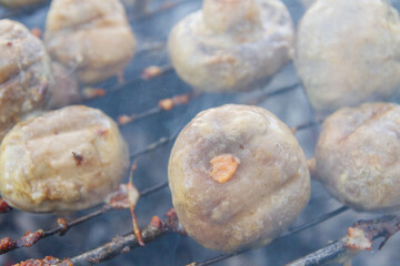 Pickled mushrooms are cooked on the grill on coals