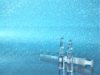 The ampoule with the COVID-19 coronavirus vaccine. Vaccines and syringes. Influenza vaccine, syringe, and vials.