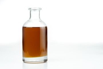 Vegetable oil in a glass bottle. Isolated on a white background.
