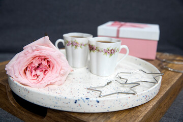 Rose White Pink O'hara. box with heart with gift are on the tray, two cup of tea and earings