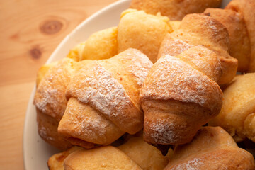 Tasty croissants on wooden table. Homemade bakery