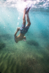 Young boy swimming underwater