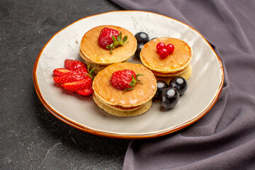 front view yummy pancakes with olives and fruits on dark background fruit sweet cake