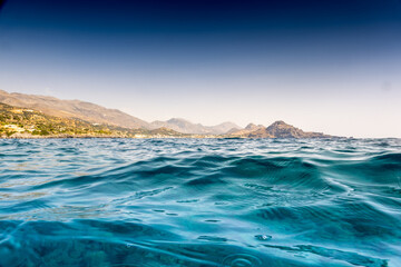 Fototapeta na wymiar Blue sea with mountains