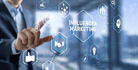 Obraz premium Man clicks on the inscription INFLUENCER MARKETING.