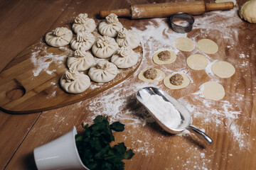 National Georgian cuisine. Khinkali with meat. Khinkali on a wooden background. Preparation process