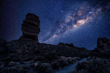 Milky Way starry sky over Roque Cinchado. Roques de García Las Canadas del TeideRoque Cinchado and Pico del Teide with starry sky Milky Way Night scene at new moon Los Roques de Garcia Las Canadas.